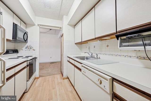800 Avondale Rd Unit 2C, Wallingford, PA 19086 - kitchen with white appliances, light wood finished floors, light countertops, white cabinets, and a textured ceiling