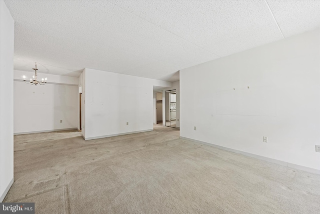 800 Avondale Rd Unit 2C, Wallingford, PA 19086 - carpeted empty room with a chandelier, a textured ceiling, and baseboards