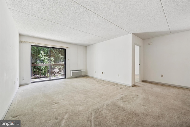 800 Avondale Rd Unit 2C, Wallingford, PA 19086 - empty room featuring carpet floors, a wall mounted AC, a textured ceiling, and baseboards