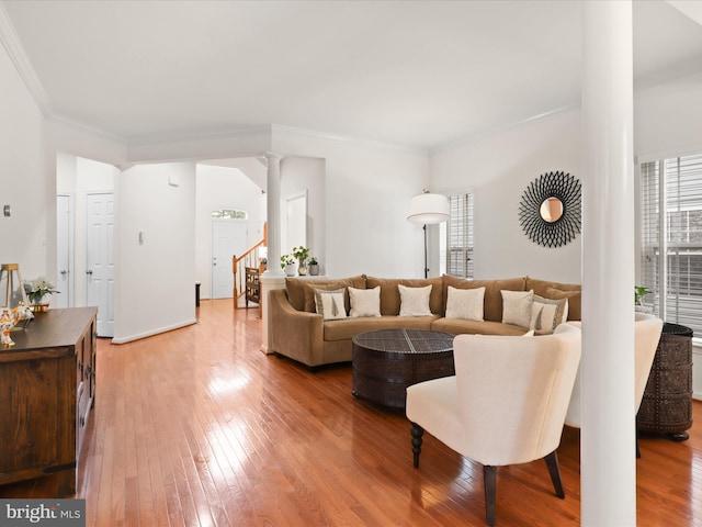 3903 Beeker Mill Pl, Chantilly, VA 20151 - living room with decorative columns, light wood-style flooring, stairs, and ornamental molding