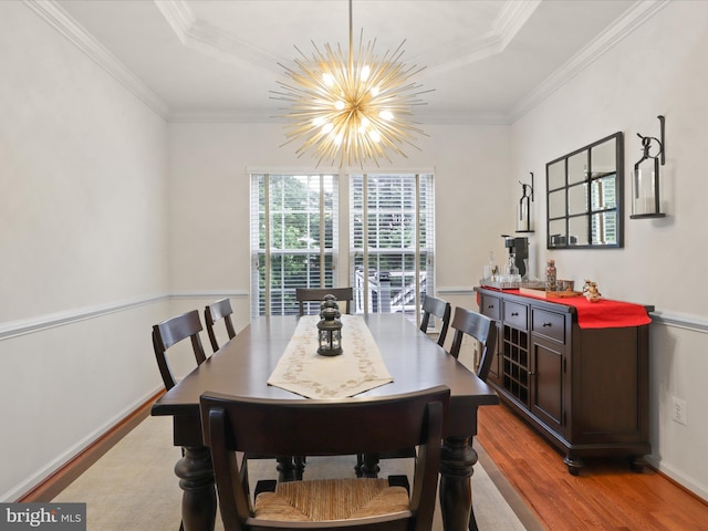 3903 Beeker Mill Pl, Chantilly, VA 20151 - dining space featuring wood finished floors, a chandelier, ornamental molding, a dry bar, and a raised ceiling