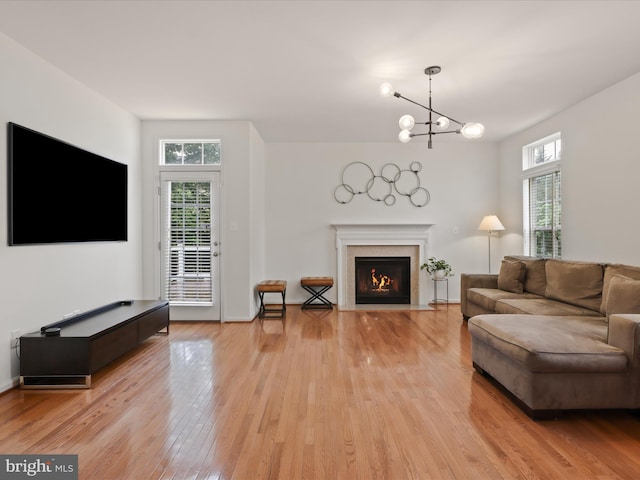 3903 Beeker Mill Pl, Chantilly, VA 20151 - living area with plenty of natural light, light wood-style flooring, a fireplace with flush hearth, and a chandelier