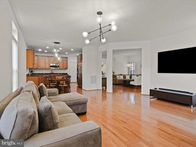 3903 Beeker Mill Pl, Chantilly, VA 20151 - living room featuring a chandelier, light wood-style floors, and recessed lighting
