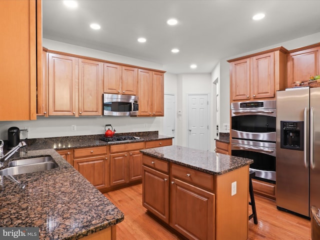 3903 Beeker Mill Pl, Chantilly, VA 20151 - kitchen featuring appliances with stainless steel finishes, light wood-style flooring, a center island, recessed lighting, and dark stone countertops