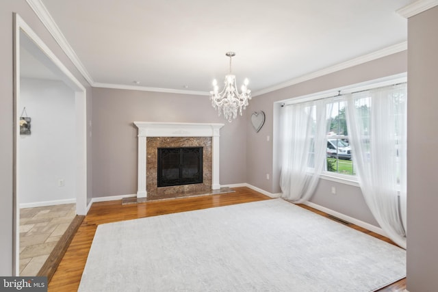 52 Marlborough Ave, Marlton, NJ 08053 - unfurnished living room with ornamental molding, baseboards, a premium fireplace, a chandelier, and wood finished floors