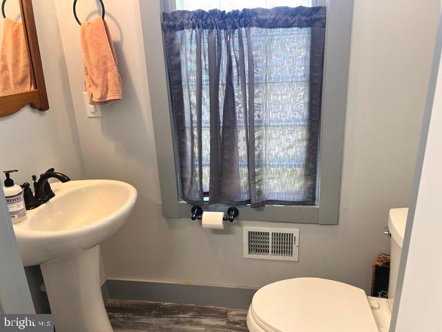 7299 Marshall St, Lincoln, DE 19960 - bathroom with toilet, baseboards, and wood finished floors
