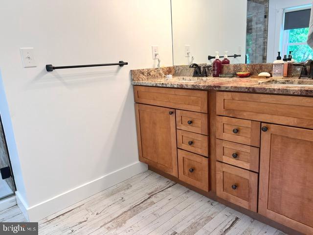 7299 Marshall St, Lincoln, DE 19960 - bathroom featuring wood finished floors, vanity, baseboards, and a shower with shower door