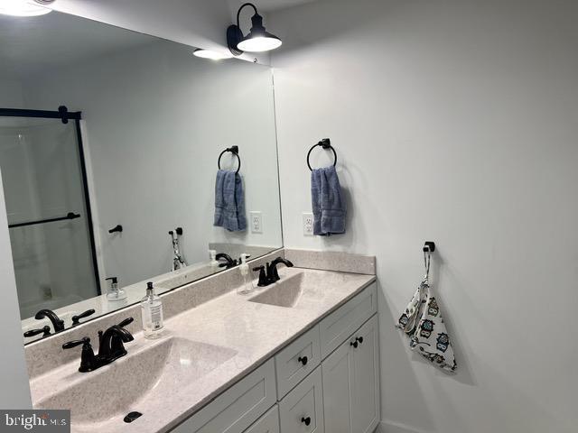 7299 Marshall St, Lincoln, DE 19960 - bathroom featuring double vanity and a shower with door