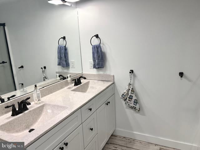 7299 Marshall St, Lincoln, DE 19960 - full bath featuring double vanity, wood finished floors, and baseboards