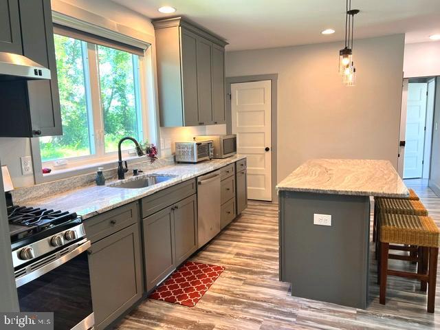 7299 Marshall St, Lincoln, DE 19960 - kitchen with stainless steel appliances, a sink, gray cabinetry, under cabinet range hood, and recessed lighting
