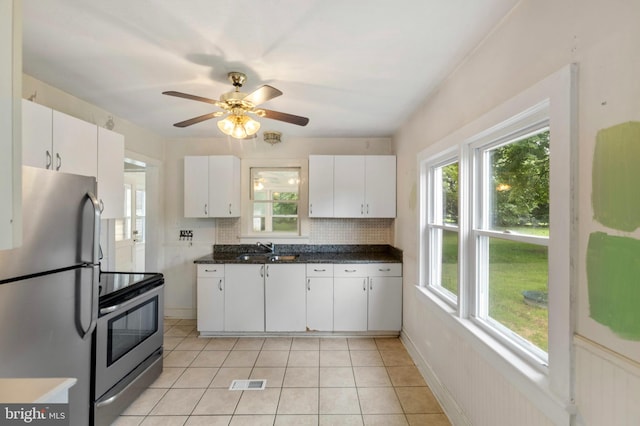 934 Fieldsboro Rd, Townsend, DE 19734 - kitchen with stainless steel appliances, a sink, white cabinets, and tasteful backsplash
