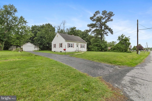 934 Fieldsboro Rd, Townsend, DE 19734 - view of front of home with a detached garage, a front lawn, an outbuilding, and asphalt driveway
