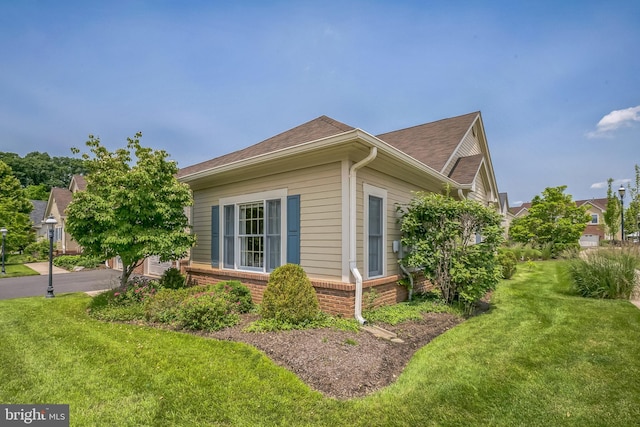 1 Hedge Row Rd, Princeton, NJ 08540 - view of home's exterior with brick siding, a yard, and roof with shingles