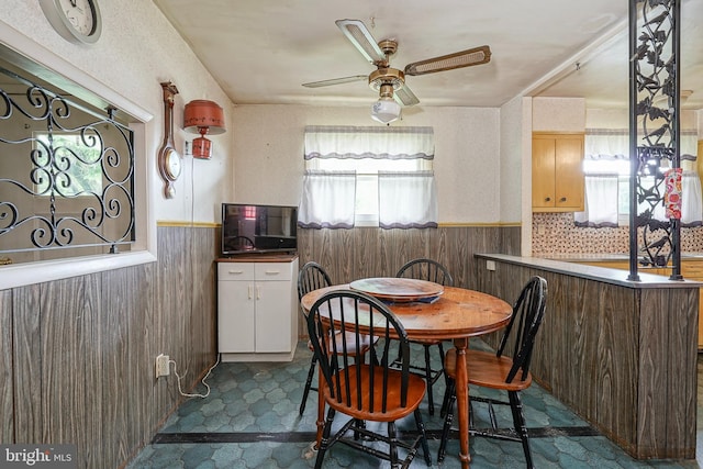 1103 Laurel Rd, Edgewater Park, NJ 08010 - dining area featuring a wainscoted wall, plenty of natural light, a ceiling fan, and wood walls