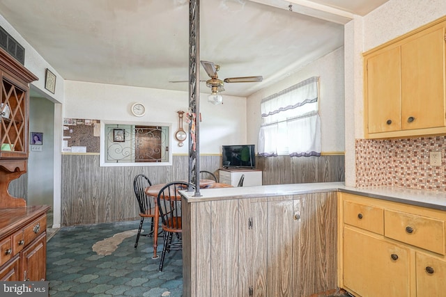 1103 Laurel Rd, Edgewater Park, NJ 08010 - kitchen featuring ceiling fan, a wainscoted wall, light brown cabinets, dark carpet, and wood walls