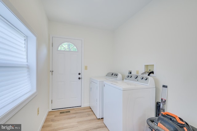 2968 Sulphur Springs Rd, Inwood, WV 25428 - washroom with washing machine and dryer and light wood-style flooring
