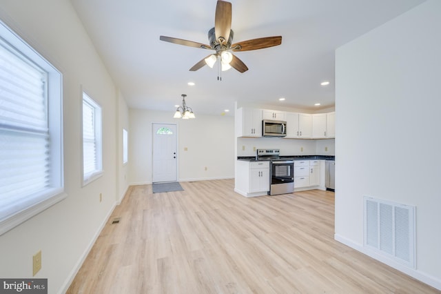 2968 Sulphur Springs Rd, Inwood, WV 25428 - unfurnished living room with a chandelier, light wood-type flooring, recessed lighting, and a ceiling fan