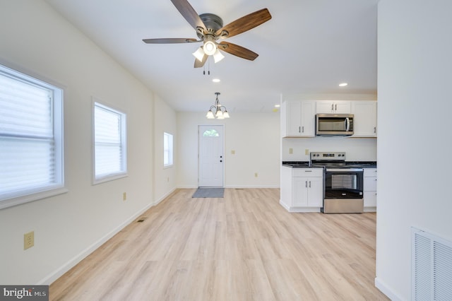 2968 Sulphur Springs Rd, Inwood, WV 25428 - kitchen with stainless steel appliances, white cabinets, light wood-style floors, dark countertops, and a ceiling fan
