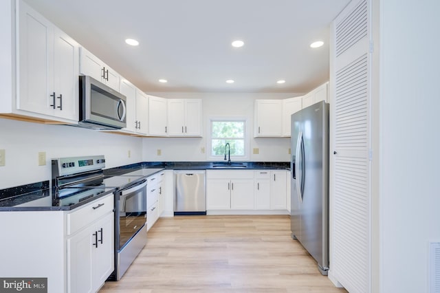 2968 Sulphur Springs Rd, Inwood, WV 25428 - kitchen with stainless steel appliances, dark countertops, white cabinets, recessed lighting, and light wood finished floors