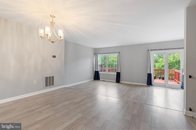 12307 Sandy Point Ct, Silver Spring, MD 20904 - empty room featuring a chandelier and wood finished floors