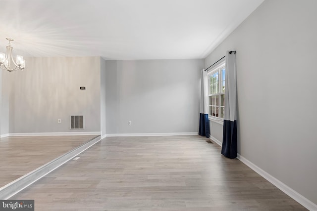 12307 Sandy Point Ct, Silver Spring, MD 20904 - unfurnished room featuring a chandelier and wood finished floors