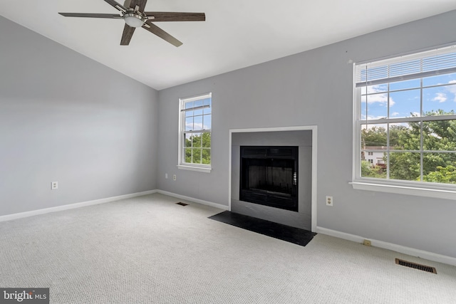 12307 Sandy Point Ct, Silver Spring, MD 20904 - unfurnished living room featuring lofted ceiling, carpet floors, a ceiling fan, and a fireplace with flush hearth