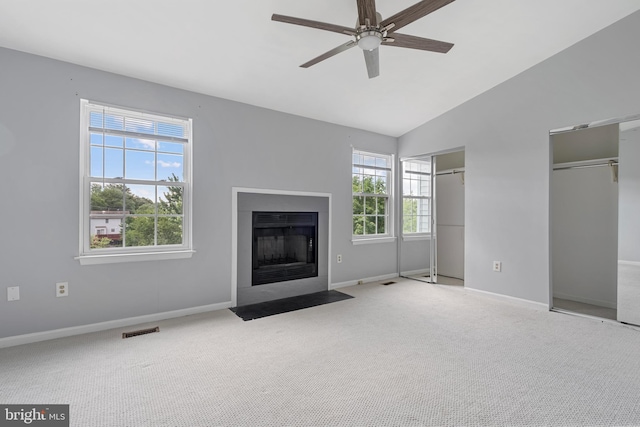 12307 Sandy Point Ct, Silver Spring, MD 20904 - unfurnished living room with healthy amount of natural light, a ceiling fan, carpet flooring, a fireplace with flush hearth, and lofted ceiling