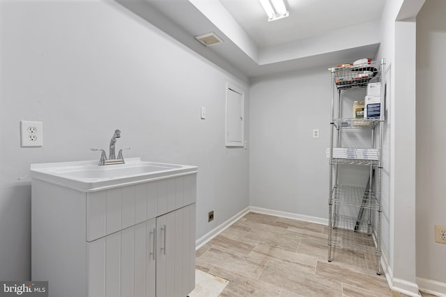 12307 Sandy Point Ct, Silver Spring, MD 20904 - laundry area featuring electric dryer hookup and cabinet space