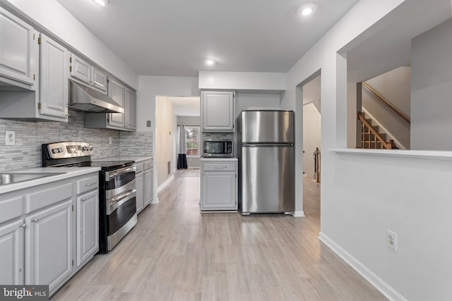12307 Sandy Point Ct, Silver Spring, MD 20904 - kitchen featuring stainless steel appliances, under cabinet range hood, gray cabinets, light wood-style flooring, and recessed lighting