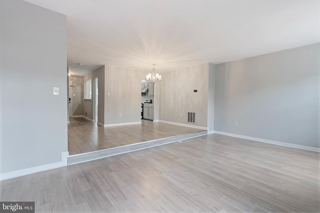 12307 Sandy Point Ct, Silver Spring, MD 20904 - spare room featuring a chandelier and light wood-style flooring
