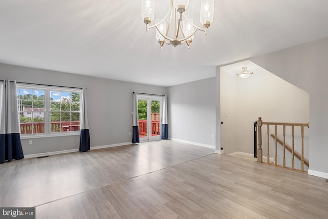 12307 Sandy Point Ct, Silver Spring, MD 20904 - unfurnished living room with wood finished floors and a chandelier