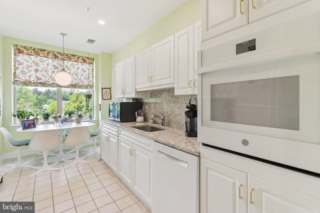 2118 Windrow Dr, Princeton, NJ 08540 - kitchen featuring dishwasher, a sink, light countertops, black microwave, and backsplash