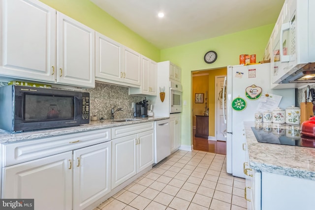 2118 Windrow Dr, Princeton, NJ 08540 - kitchen with black appliances, a sink, light tile patterned flooring, white cabinets, and light countertops