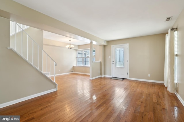 15 Woodvale Dr, Atco, NJ 08004 - unfurnished living room with a chandelier, stairs, hardwood / wood-style floors, and baseboards