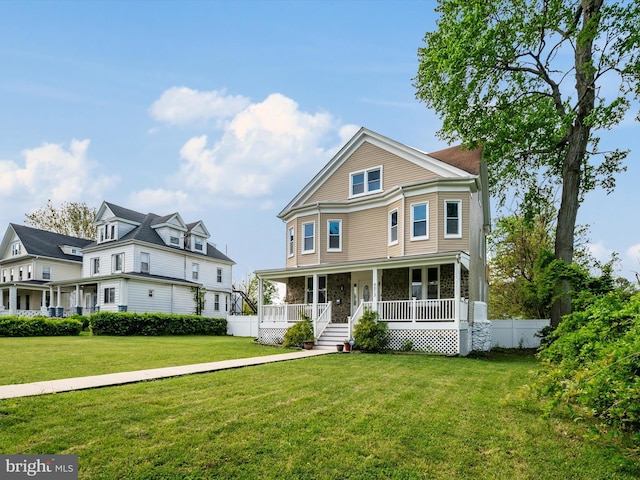 4013 Maine Ave, Baltimore, MD 21207 - victorian-style house featuring a porch, a front lawn, and stone siding