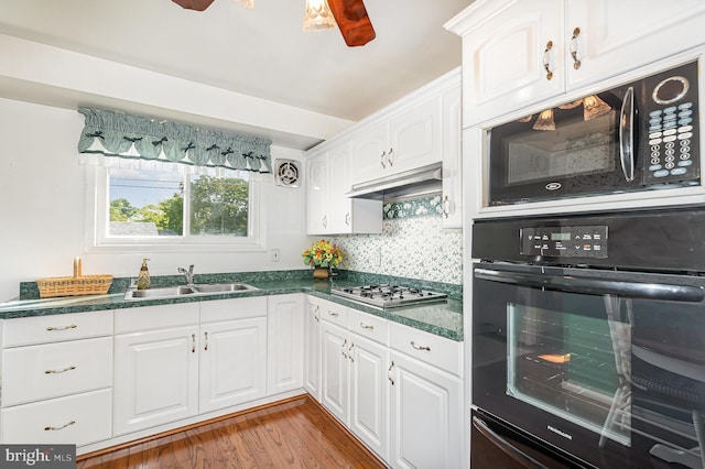 1513 Chapel Hill Dr, Baltimore, MD 21237 - kitchen with black appliances, a sink, dark countertops, and white cabinetry