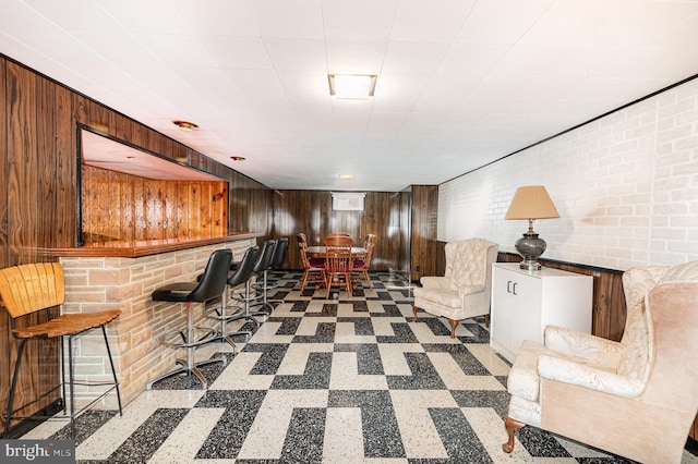 1513 Chapel Hill Dr, Baltimore, MD 21237 - living area with tile patterned floors, a dry bar, and wooden walls