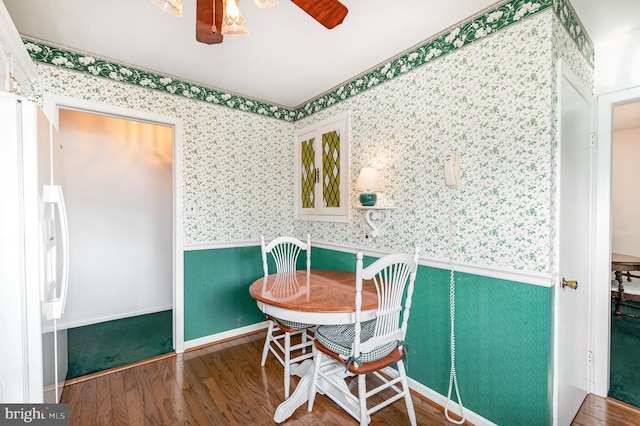 1513 Chapel Hill Dr, Baltimore, MD 21237 - dining area featuring wallpapered walls, a wainscoted wall, wood finished floors, and a ceiling fan