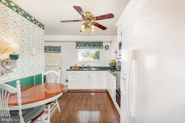 1513 Chapel Hill Dr, Baltimore, MD 21237 - kitchen with white refrigerator with ice dispenser, a sink, dark countertops, dark wood-type flooring, and wallpapered walls
