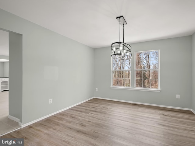 4300 Cullowhee Ct, Clinton, MD 20735 - spare room featuring a chandelier, wood finished floors, and baseboards