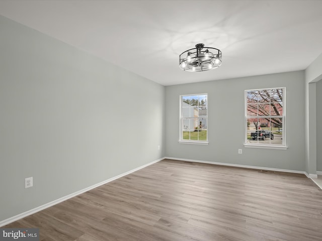 4300 Cullowhee Ct, Clinton, MD 20735 - empty room with wood finished floors, a chandelier, and baseboards