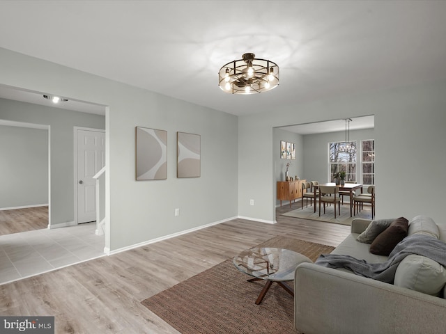 4300 Cullowhee Ct, Clinton, MD 20735 - living room with a chandelier, light wood-style floors, and baseboards