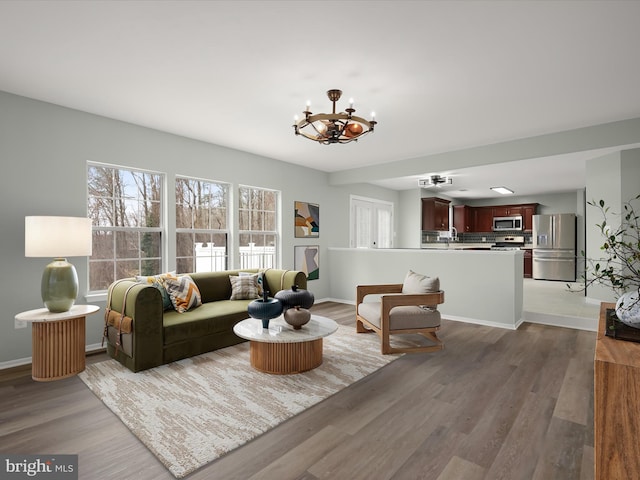 4300 Cullowhee Ct, Clinton, MD 20735 - living area with a chandelier, wood finished floors, and baseboards