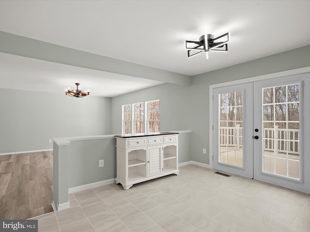 4300 Cullowhee Ct, Clinton, MD 20735 - unfurnished dining area featuring ceiling fan, a chandelier, baseboards, and french doors