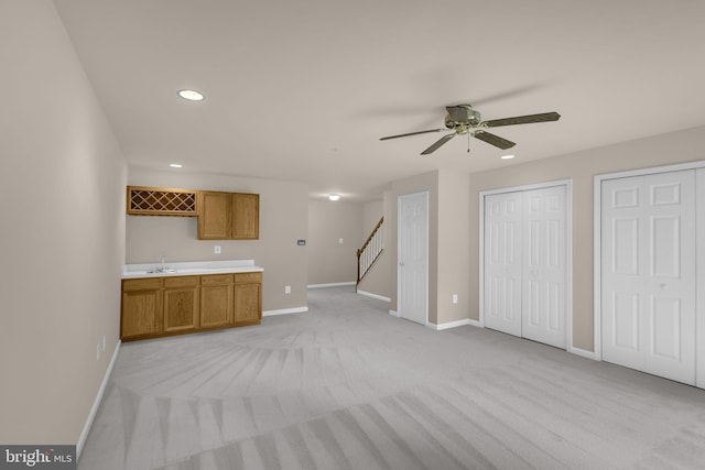 11476 Leland Pl, Waldorf, MD 20601 - unfurnished living room with baseboards, light carpet, a ceiling fan, bar with sink, and recessed lighting
