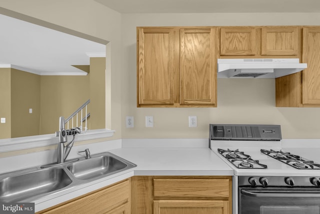 11476 Leland Pl, Waldorf, MD 20601 - kitchen featuring gas range, under cabinet range hood, a sink, light countertops, and crown molding
