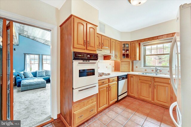 29 S Rockburn St, York, PA 17402 - kitchen featuring a warming drawer, white appliances, a sink, under cabinet range hood, and tasteful backsplash