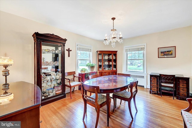 29 S Rockburn St, York, PA 17402 - dining area featuring radiator heating unit, plenty of natural light, a chandelier, and light wood-style flooring