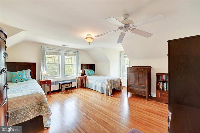 29 S Rockburn St, York, PA 17402 - bedroom featuring radiator, vaulted ceiling, multiple windows, light wood-type flooring, and a ceiling fan