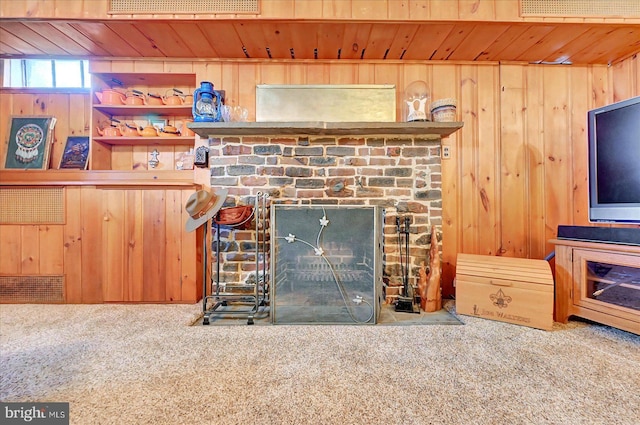 29 S Rockburn St, York, PA 17402 - unfurnished living room with carpet flooring, wood walls, wood ceiling, and a brick fireplace
